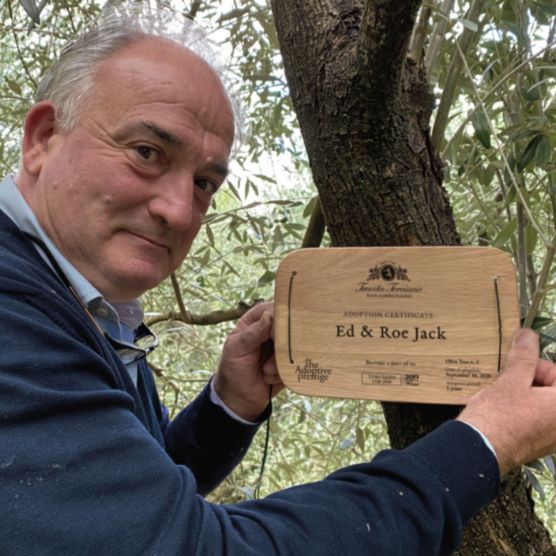 A wooden adoption plaque engraved with an adopter’s name